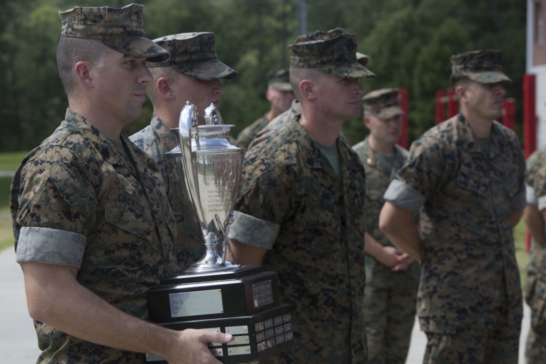 Marines from the rifle team of 2nd Battalion, 8th Marine Regiment prepare to present the Elliot Trophy to Major General John K. Love at Camp Lejeune, N.C. Sep. 1, 2017. The Elliot Trophy is awarded to the rifle team that scores the highest during an annual shooting competition. This year marks the first time a rifle team from 2nd Marine Division won the trophy in over 55 years. (U.S. Marine Corps photo by Lance Cpl. Damarko Bones)
