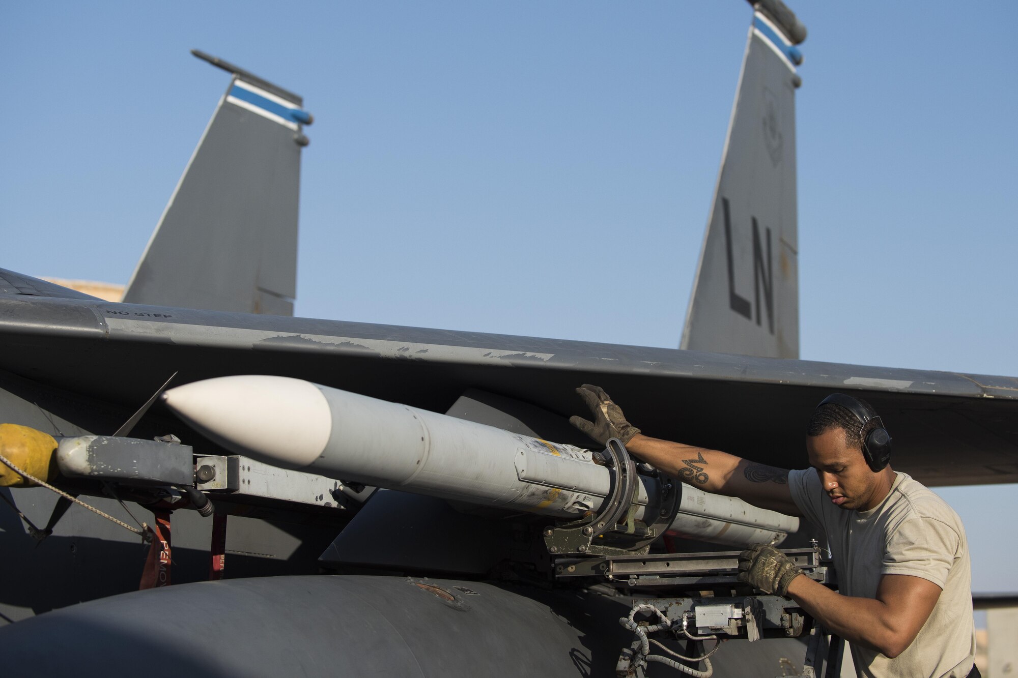 Tech. Sgt. Keith Rochford, 332nd Expeditionary Maintenance Squadron weapons load crew chief, offloads a missile from an F-15E Strike Eagle, August 13, 2017, in Southwest Asia. Missiles must be routinely inspected to ensure they will function properly when needed. (U.S. Air Force photo/Senior Airman Damon Kasberg)