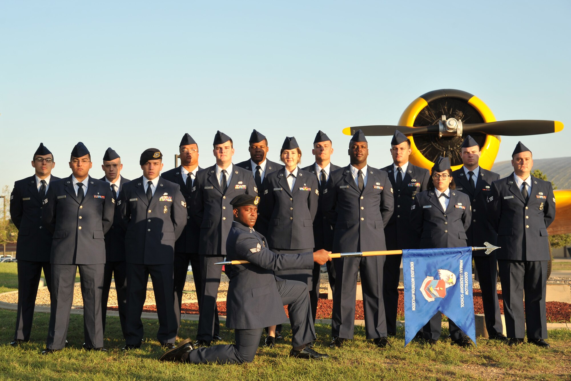 Airman Leadership School Class 17-F stands before the T-6 Texan static plane display on Goodfellow Air Force Base, Texas, Aug. 31, 2017. ALS is a six-week course designed to prepare senior airmen to assume supervisory duties, offering instruction in leadership and followership, written and oral communication skills, and the profession of arms. (U.S. Air Force photo by Airman 1st Class Randall Moose/Released)