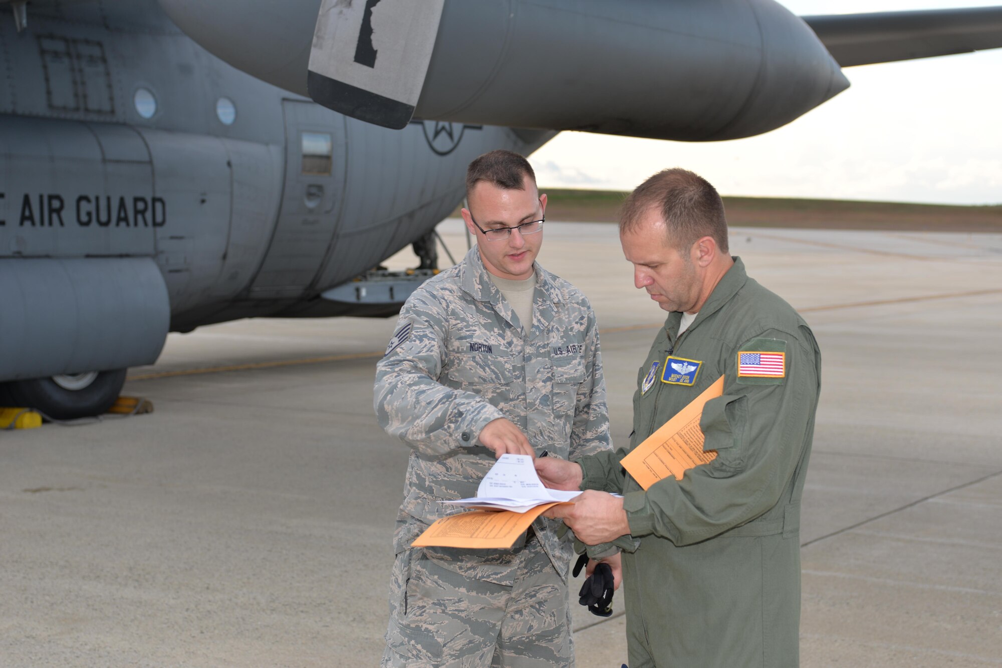 TSgt Andrew Norton, air transportation specialist, 157th Logistic Readiness Squadron, and Master Sgt. Mickey Dixon, Load Master, 142nd Air Lift Squadron, New Castle, Delaware discuss payload information prior to loading a Disaster Relief Bed Down Kit (DRBS) onto a C-130 Hercules Aircraft for deployment to the Virgin Islands in response to the Irma relief effort at Pease Air National Guard Base.  (N.H. Air National Guard Photo by Master Sgt. Thomas Johnson)