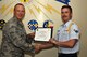 U.S. Air Force Lt. Col. Steven Watts, 17th Training Group Deputy commander, presents the 315th Training Squadron Student of the Month award for August 2017 to Airman 1st Class Cole Mossman, 315th Training Squadron student, at Brandenburg Hall on Goodfellow Air Force Base, Texas, Sept. 8, 2017. (U.S. Air Force photo by Senior Airman Scott Jackson/Released)