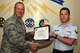 U.S. Air Force Lt. Col. Steven Watts, 17th Training Group Deputy commander, presents the 312th Training Squadron Student of the Month award for August 2017 to Airman 1st Class Kyle Gruenberg, 312th Training Squadron student, at Brandenburg Hall on Goodfellow Air Force Base, Texas, Sept. 8, 2017. (U.S. Air Force photo by Senior Airman Scott Jackson/Released)