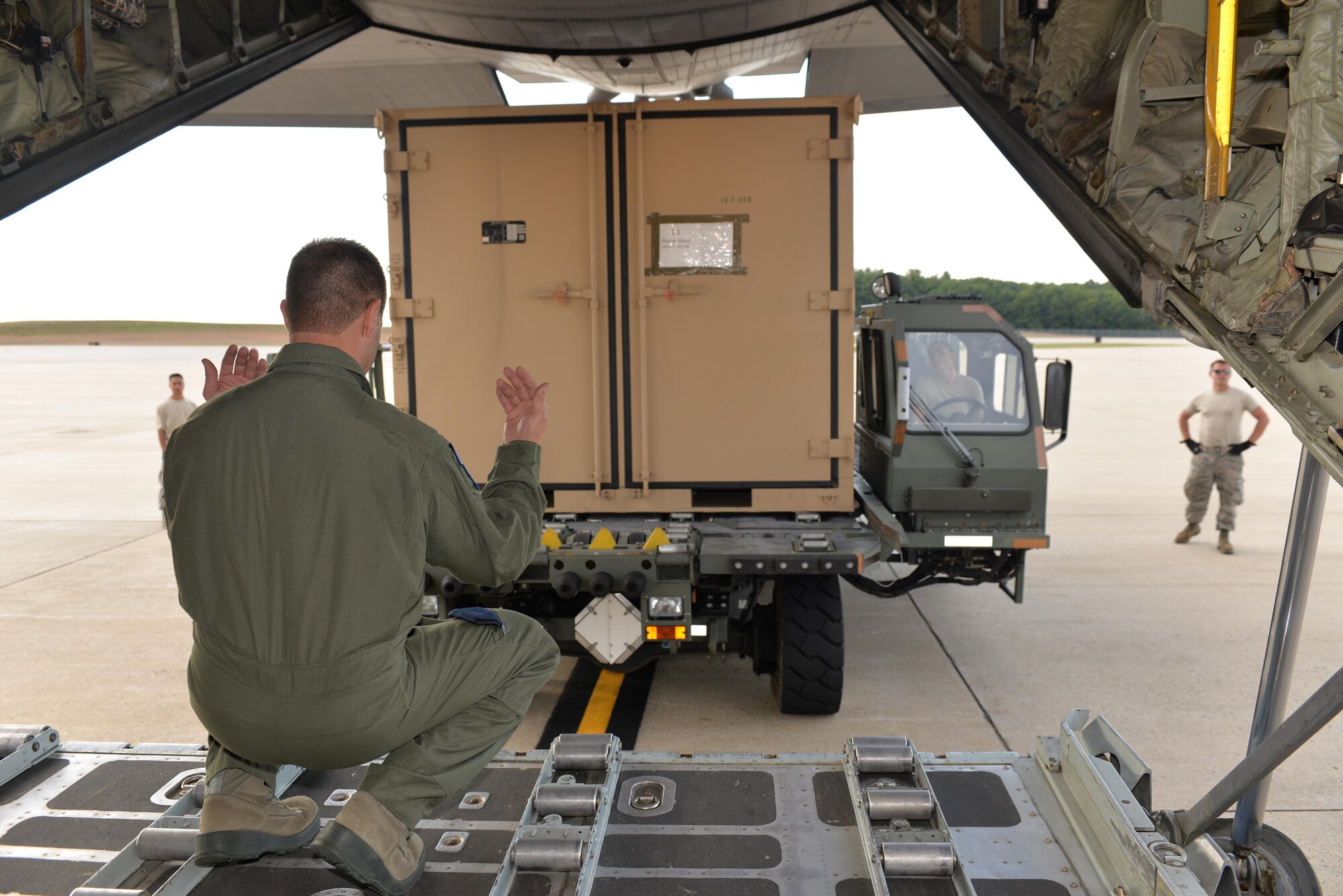 SrA Alyssa Rosenberg, ramp services representative, 157th Air Refueling Wing, operates a K loader as Master Sgt. Micky Dixon, Load Master, 142nd Air Lift Squadron, New Castle, Delaware, guides equipment from the Disaster Relief Bed Down Kit (DRBS) onto a C-130 Hercules aircraft for deployment to the Virgin Islands as part of the Irma Relief effort. The DRBS kit is one of two kits stored here at Pease Air National Guard Base.  (N.H. Air National Guard Photo by Master Sgt. Thomas Johnson)