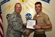 U.S. Air Force Lt. Col. Steven Watts, 17th Training Group Deputy commander, presents the 316th Training Squadron Student of the Month award for August 2017 to U.S. Marine Corps Lance Cpl. Jarrad Smith, 316th Training Squadron student, at Brandenburg Hall on Goodfellow Air Force Base, Texas, Sept. 8, 2017. (U.S. Air Force photo by Senior Airman Scott Jackson/Released)