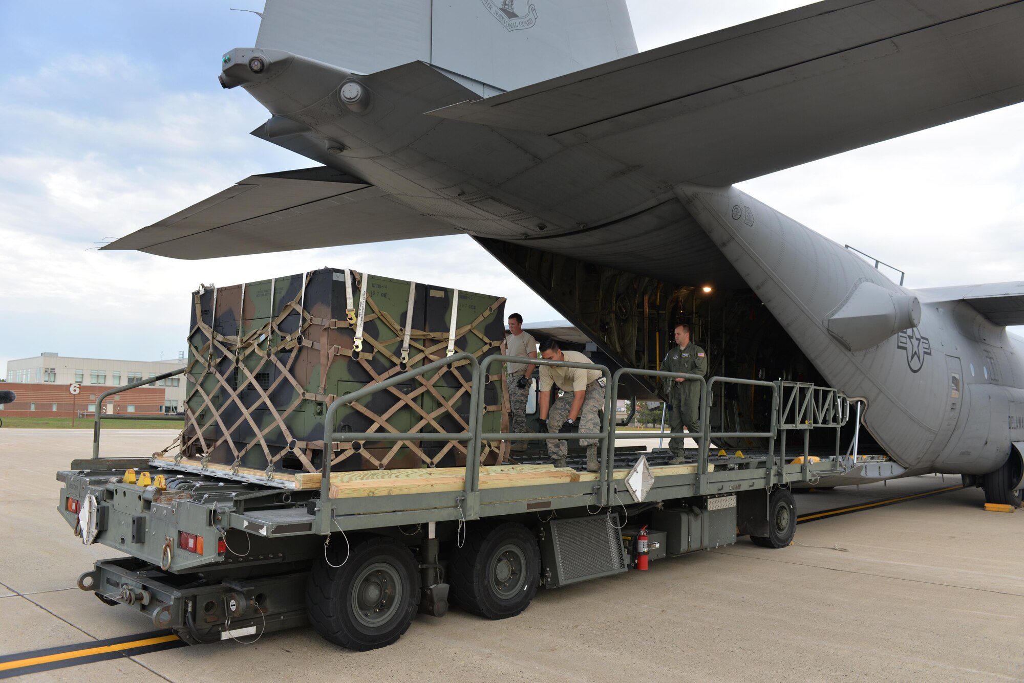 Air National Guard Airman from the 142nd Air Lift Squadron, New Castle, Delaware, guide equipment from the Disaster Relief Bed Down Kit (DRBS) onto a C-130 Hercules aircraft for deployment to the Virgin Islands as part of the Irma Relief effort. The DRBS kit is one of two kits stored here at Pease Air National Guard Base.  (N.H. Air National Guard Photo by Master Sgt. Thomas Johnson)