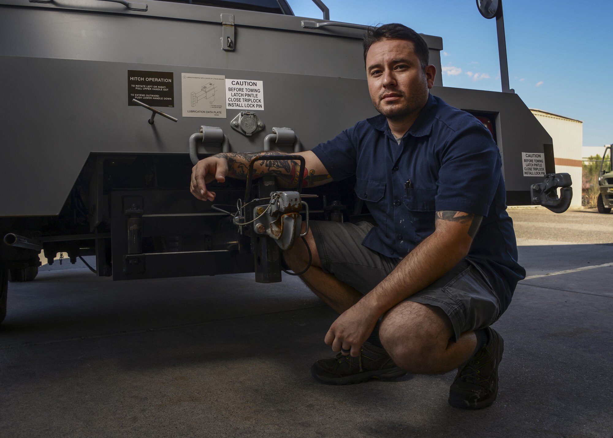 Daniel Villela, 56th Logistics Readiness Squadron mobile equipment mechanic, poses for a portrait next to the pintle hook assembly on a bobtail Sept. 14, 2017 at Luke Air Force Base, Ariz. Villela was the lead mechanic to provide the steps in reconfiguring and implementing a fix to the pintle hook mechanism for the bobtails that tow the F-35 on the flightline at Luke. (U.S. Air Force photo/Airman 1st Class Caleb Worpel)