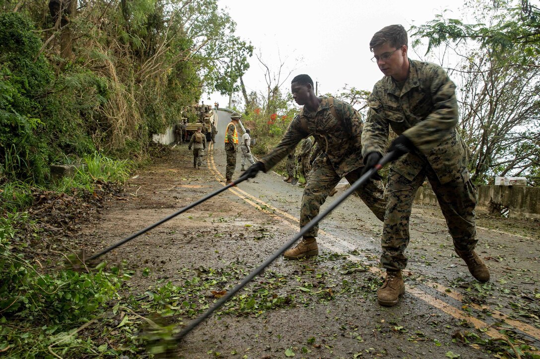 U.S. Marine Cpl. Marcel T. Trice, left, and Cpl. Anthony J. Guiliano III, combat engineers with Battalion Landing Team 2nd Battalion, 6th Marine Regiment, 26th Marine Expeditionary Unit (MEU), clear out debris from roadways for communities affected by Hurricane Irma in St. Thomas, U.S. Virgin Islands, Sept. 14, 2017. The 26th MEU is supporting authorities in the U.S. Virgin Islands with the combined goal of protecting the lives and safety of those in affected areas. (U.S. Marine Corps photo by Lance Cpl. Tojyea G. Matally)