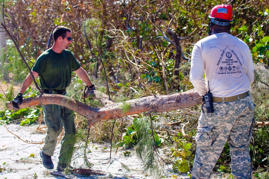 Florida Army National Guardsmen clear tree branches in Key West, Fla.