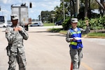Specialist Brandon Moorley, military police for the 715th Military Police Company, and Airman 1st Class Kara Fredrickson, services apprentice at the125th Force Support Squadron, inspect vehicles at the Exit Control Point for the State Logistics Response Center Axillary Staging Area in Orlando, Fla. Sept. 13, 2017. The ASA provides additional space to process incoming logistical support from FEMA and contractors in the aftermath of natural disasters.