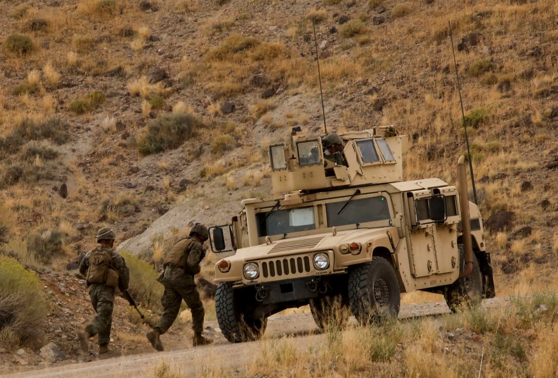 Marines run back to their vehicle after an improvised explosive device detonates during a convoy operation as part of the final exercise of Mountain Warfare Training in Bridgeport, Calif., Sept. 5, 2017. Mountain Warfare Training prepares Marines to fight in high altitude and low temperature environments through a series of training exercises, followed by a final practical application that combines and tests the learned skills.