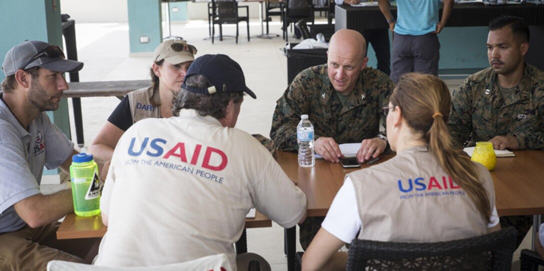 U.S. Marines Col. Michael V. Samarov, center, commander of Joint Task Force - Leeward Islands, and Capt. Ismael Lopez, the civil military operations planner for JTF-LWI, meet with members of the United States Agency for International Development at Saint Martin, Sept. 13, 2017