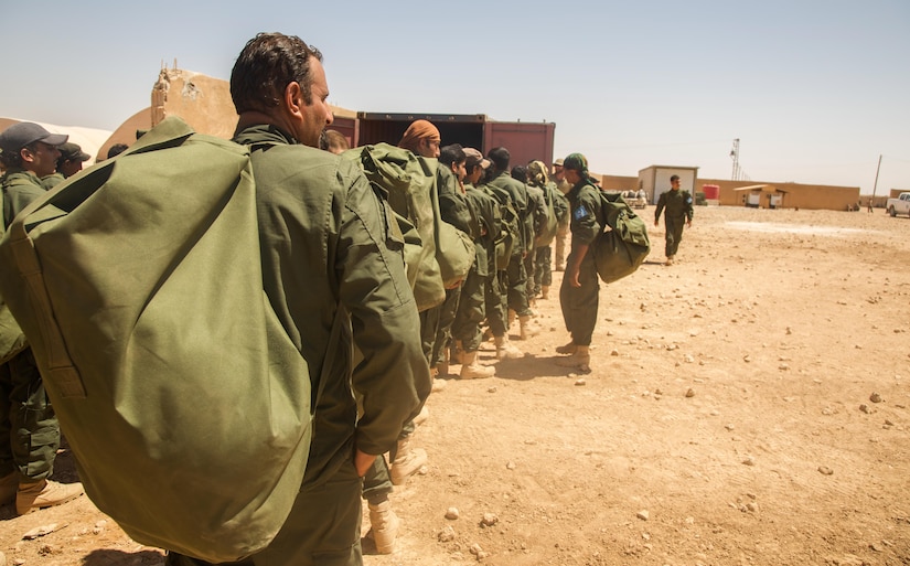 Raqqa Internal Security Force Training Class 005 graduates receive their initial issue of equipment after completing their training in Ayn Issa, Syria.