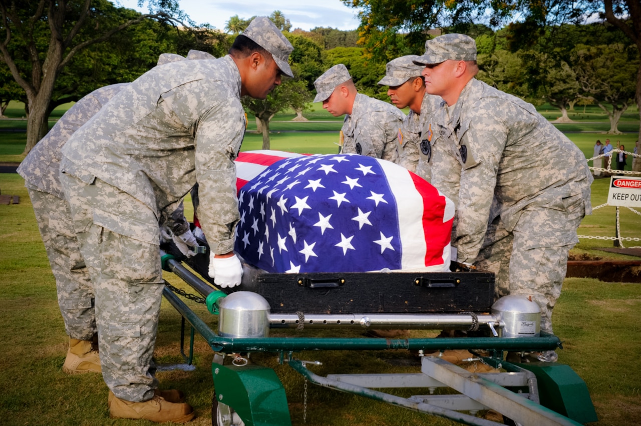 U.S. service members from the Defense POW/MIA Accounting Agency participate in a disinterment ceremony, July 13, at the National Memorial Cemetery of the Pacific