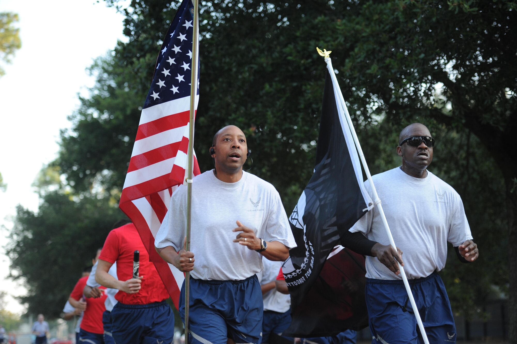 Senior Master Sgt. Linford Smith, 81st Surgical Operations Squadron first sergeant, and Chief Master Sgt. Tommy Belcher, 81st MSGS superintendent, participate in Keesler’s POW/MIA 24-hour memorial run and vigil at the Crotwell Track Sept. 14, 2017, on Keesler Air Force Base, Mississippi. The event was held to raise awareness and pay tribute to all prisoners of war and those military members still missing in action. (U.S. Air Force photo by Kemberly Groue)