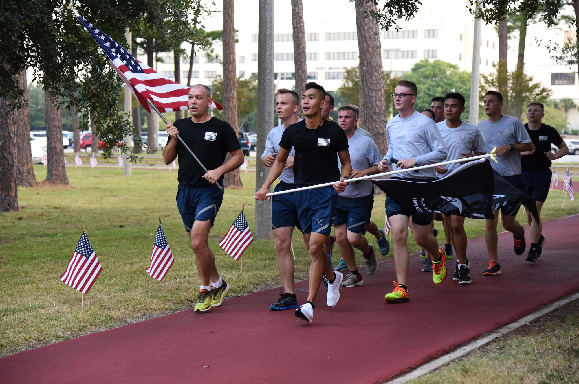 Members of the 81st Communications Squadron run the final laps during Keesler’s POW/MIA 24-hour memorial run and vigil at the Crotwell Track Sept. 14, 2017, on Keesler Air Force Base, Mississippi. The event was held to raise awareness and pay tribute to all prisoners of war and those military members still missing in action. (U.S. Air Force photo by Kemberly Groue)