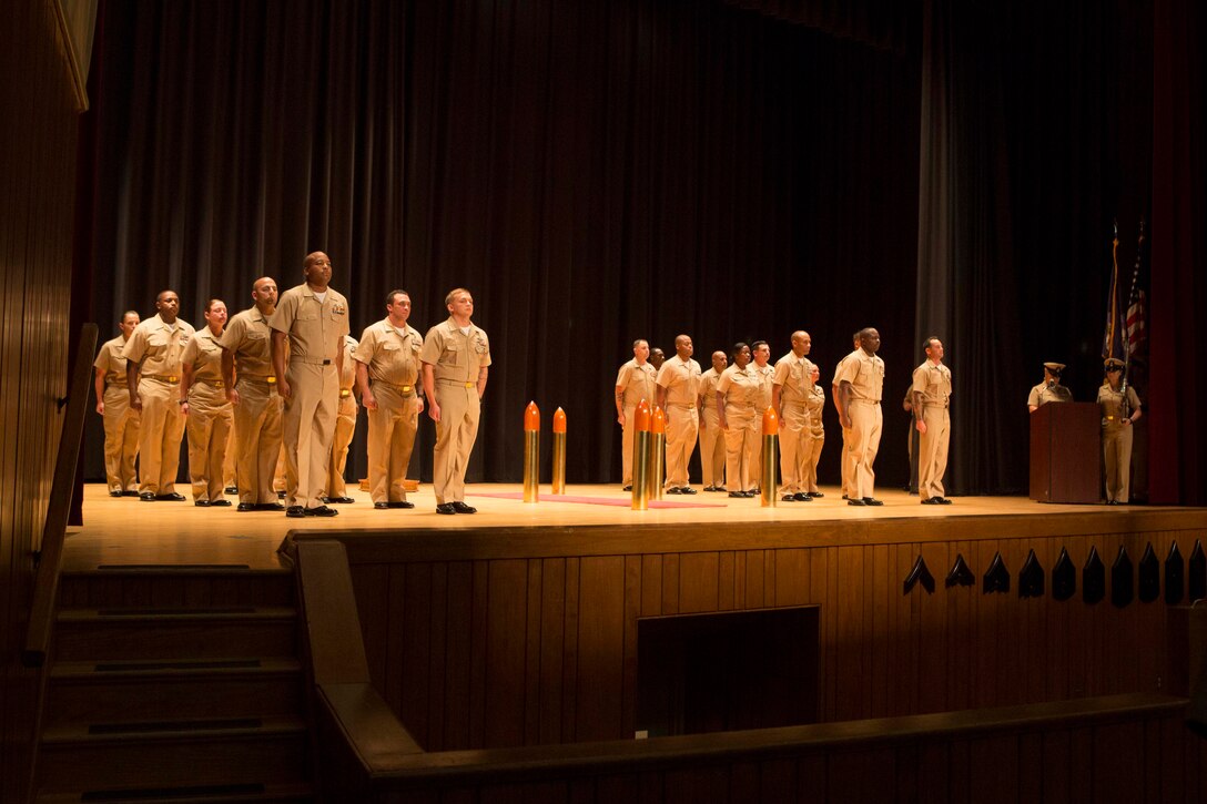 Sailors with 2nd Marine Logistics Group prepare to be promoted to Chief Petty Officer during a chief pinning ceremony at Camp Lejeune, N.C., Sept. 15, 2017. Navy Chief Petty Officers are both technical experts who train newly-commissioned junior officers and leaders whose commands are strictly followed by their subordinates. (U.S. Marine Corps photo by Lance Cpl. Abrey D. Liggins.)