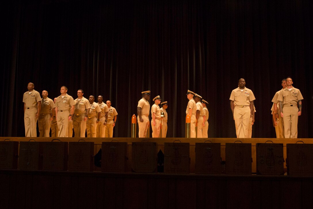 Sailors with 2nd Marine Logistics Group prepare to be promoted to Chief Petty Officer during a chief pinning ceremony at Camp Lejeune, N.C., Sept. 15, 2017. Navy Chief Petty Officers are both technical experts who train newly-commissioned junior officers and leaders whose commands are strictly followed by their subordinates. (U.S. Marine Corps photo by Lance Cpl. Abrey D. Liggins.)