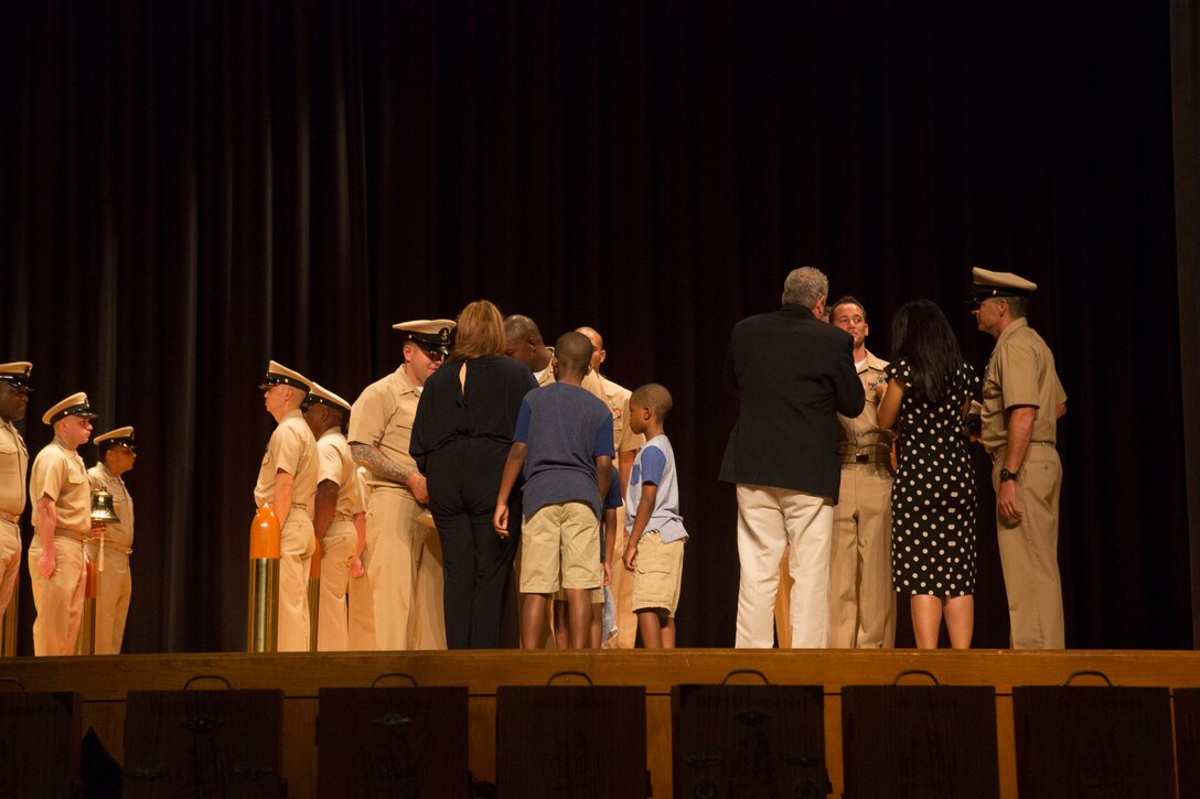 Sailors with 2nd Marine Logistics Group are pinned to Chief Petty Officer by their families and sponsors during a chief pinning ceremony at Camp Lejeune, N.C., Sept. 15, 2017. Navy Chief Petty Officers are both technical experts who train newly-commissioned junior officers and leaders whose commands are strictly followed by their subordinates.  (U.S. Marine Corps photo by Lance Cpl. Abrey D. Liggins.)