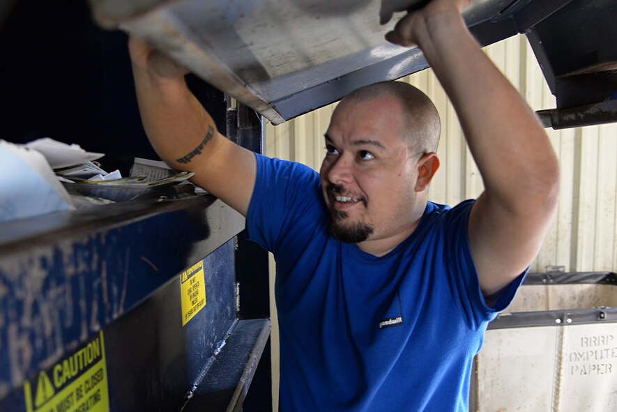Mike Cardenas, Laughlin Air Force Base, Texas recycler, shovels paper into a compactor at the recycling center here Sept. 15, 2017. Last year, Laughlin saved more than 300 yards of waste from being placed into Del Rio landfills