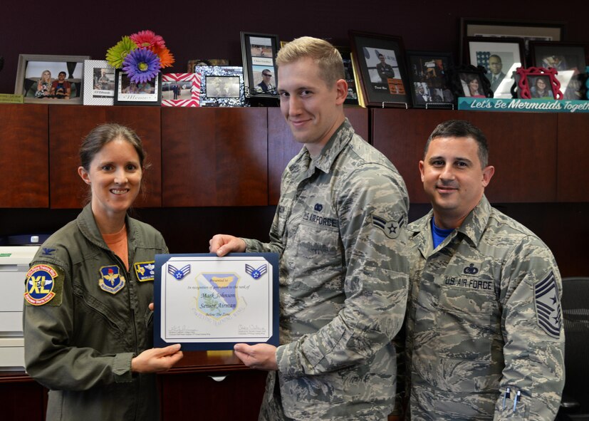 Airman 1st Class Mark Johnson, 47th Flying Training Wing protocol, accepts a “Below the Zone” award from Col. Michelle Pryor, 47th FTW vice commander, and Chief Master Sgt. George Richey, 47th FTW command chief, at Laughlin Air Force Base, Texas, Sept. 15, 2017.  The award is presented to outstanding Airmen who perform well beyond their peers, and allows for an early promotion to the next rank of Senior Airman.