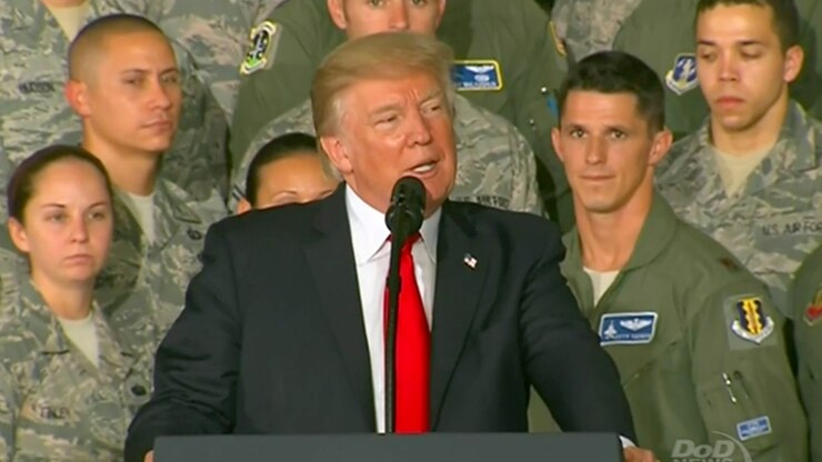 President Donald J. Trump speaks at a lectern.