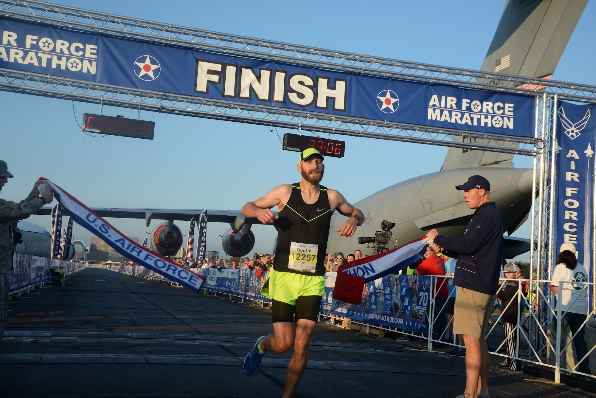 Dustin Sprague crosses the finish line as the overall men's winner of the 10K race at the 21st running of the 2017 U.S. Air Force Marathon at Wright-Patterson Air Force Base on Sept. 16.  Sprague, from Dayton, Ohio, finished with a time of 33:04.  (U.S. Air Force photo / R.J. Oriez)
