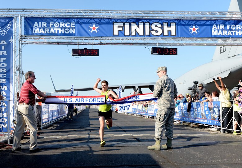 Jason Salyer crosses the finish line as the overall men's winner of the half maarathon at the 21st running of the 2017 U.S. Air Force Marathon at Wright-Patterson Air Force Base on Sept. 16. Salyer, from Columbus, Ohio, finished with a time of 1:13:34. (U.S. Air Force photo / Wesley Farnsworth)