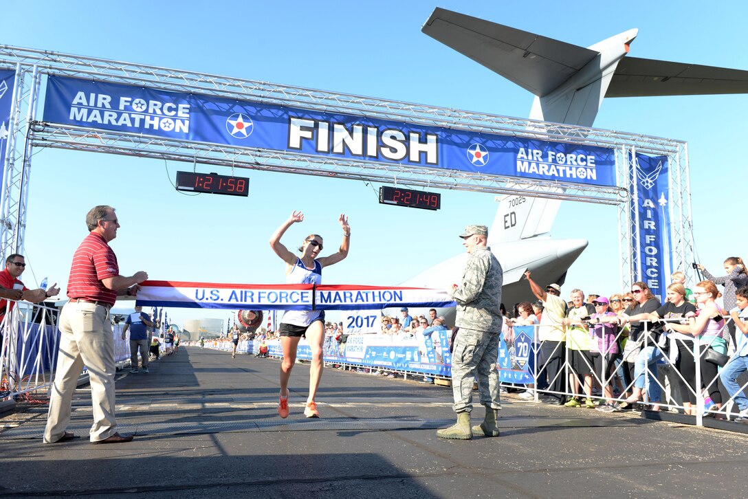 Tech. Sgt. Emily Shertzer crosses the finish line as the overall women's winner of the half marathon at the 21st running of the 2017 U.S. Air Force Marathon at Wright-Patterson Air Force Base on Sept. 16. Shertzer, from Jonestown, Pennsylvania, finished with a time of 1:21:56. (U.S. Air Force photo / Wesley Farnsworth)