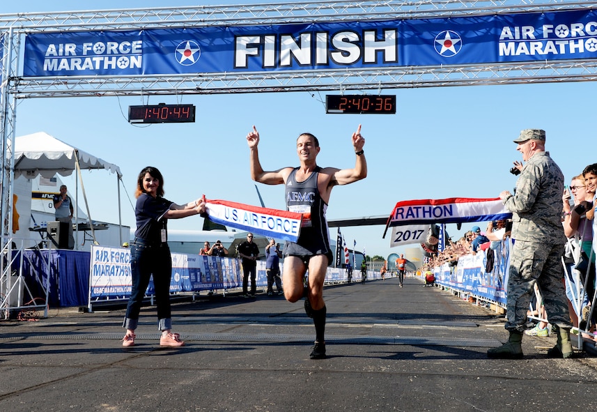 Maj. Bryan Kelly, Air Force Materiel Command test pilot from Edwards Air Force Base, California, crosses the finish line as the overall men's winner of the full marathon at the 21st running of the 2017 U.S. Air Force Marathon at Wright-Patterson Air Force Base on Sept. 16. Kelly, from Edwards, California, finished with a time of 2:30:34. (U.S. Air Force photo / Wesley Farnsworth)