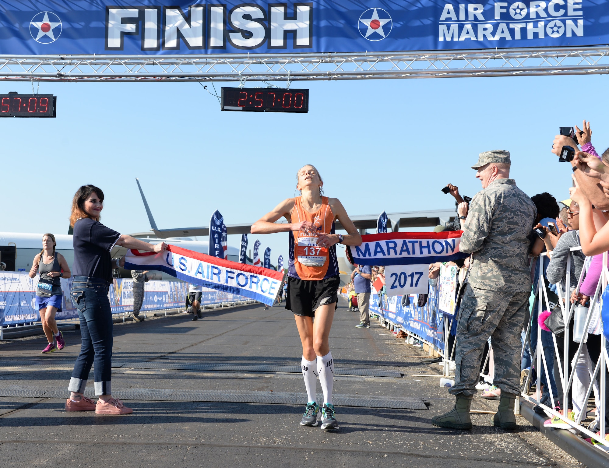 Ann Alyanak crosses the finish line as the overall women's winner of the full marathon at the 21st running of the 2017 U.S. Air Force Marathon at Wright-Patterson Air Force Base on Sept. 16. Alyanak, from Bellbrook, Ohio, finished with a time of 2:56:57. (U.S. Air Force photo / Wesley Farnsworth)