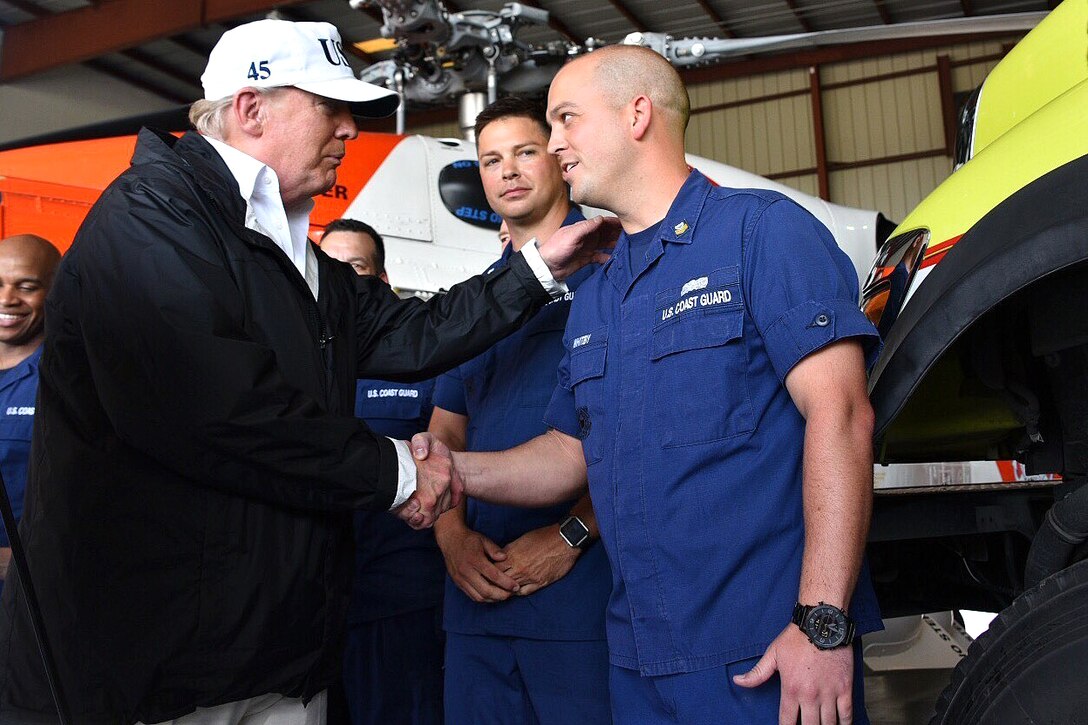 Trump greets Coast Guard members after arriving in Florida.
