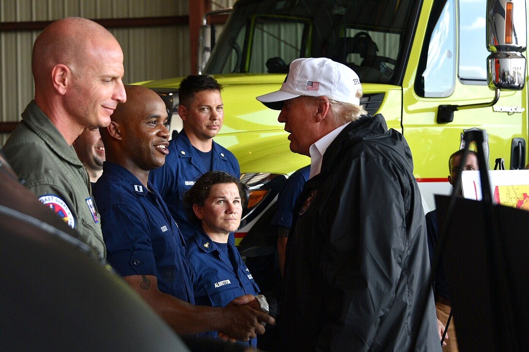 Trump greets Coast Guard members after arriving in Florida.