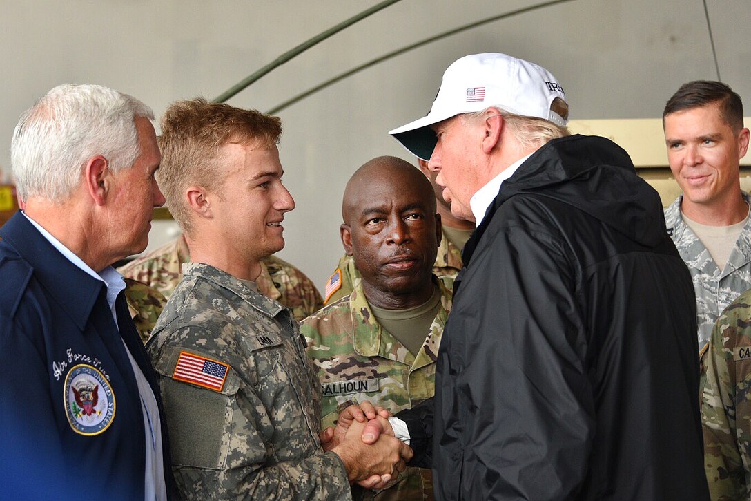President Trump shakes hands with a soldier.