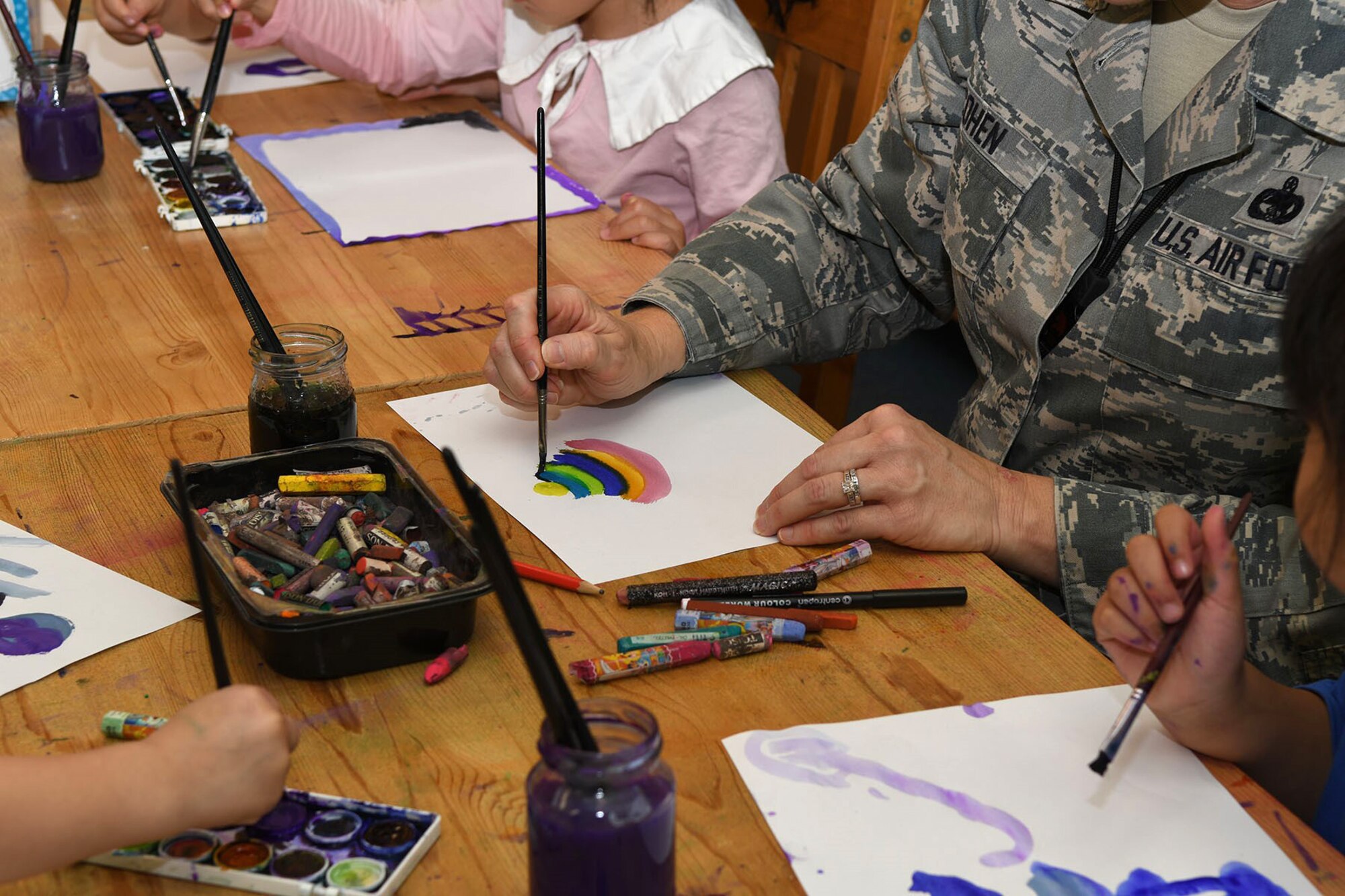 Chief Master Sgt. Shelley Cohen, the command chief master sergeant for the 307th Bomb Wing, paints a picture of her favorite toy along with students while answering questions about the U.S. Air Force and 307th BW during a visit to the 1st International School of Ostrava, Czech Republic, Sept. 15, 2017.