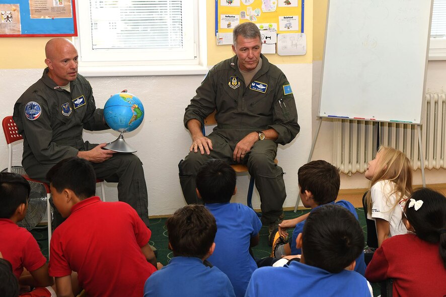 Brig. Gen. Jonathan Ellis, the mobilization assistant to the 8th Air Force Commander, and Col. Robert VanHoy, the 307th Bomb Wing commander, talk to students at the 1st International School of Ostrava, Czech Republic, about maps, flight routes and the physical requirements for being a bomber pilot, Sept. 15, 2017.