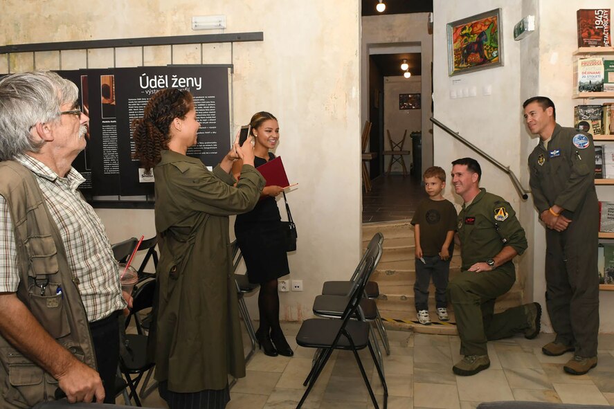 Col. Brian McClanahan, the 489th Bomb Group commander, and Lt. Col. Chris Chandler, the 93rd Bomb Squadron director of operations, take a moment to snap a photo with a young boy after a panel discussion at the PANT Centrum in Ostrava, Czech Republic Sept. 9, 2017.