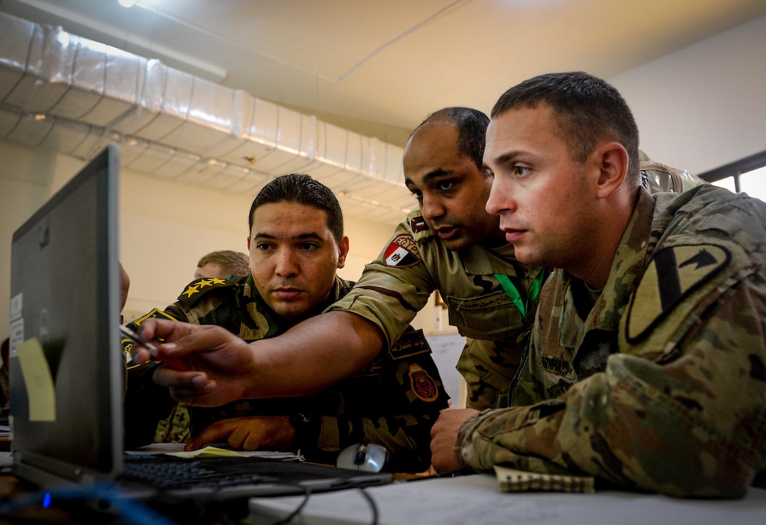 U.S. Army 1st Daniel Bernhard, 2nd Battalion, 7th Cavalry Regiment, 3rd Armored Combat Team, 1st Cavalry Division assistant operations officer, speaks with two Egyptian solider during a command-post exercise portion of Bright Star 2017, Sept. 15, 2017, at Mohamed Naguib Military Base, Egypt. More than 200 U.S. service members are participating alongside the Egyptian armed forces for the bilateral U.S. Central Command Exercise Bright Star 2017, Sept. 10 - 20, 2017 at Mohamed Naguib Military Base, Egypt. (U.S. Air Force photo by Staff Sgt. Michael Battles)