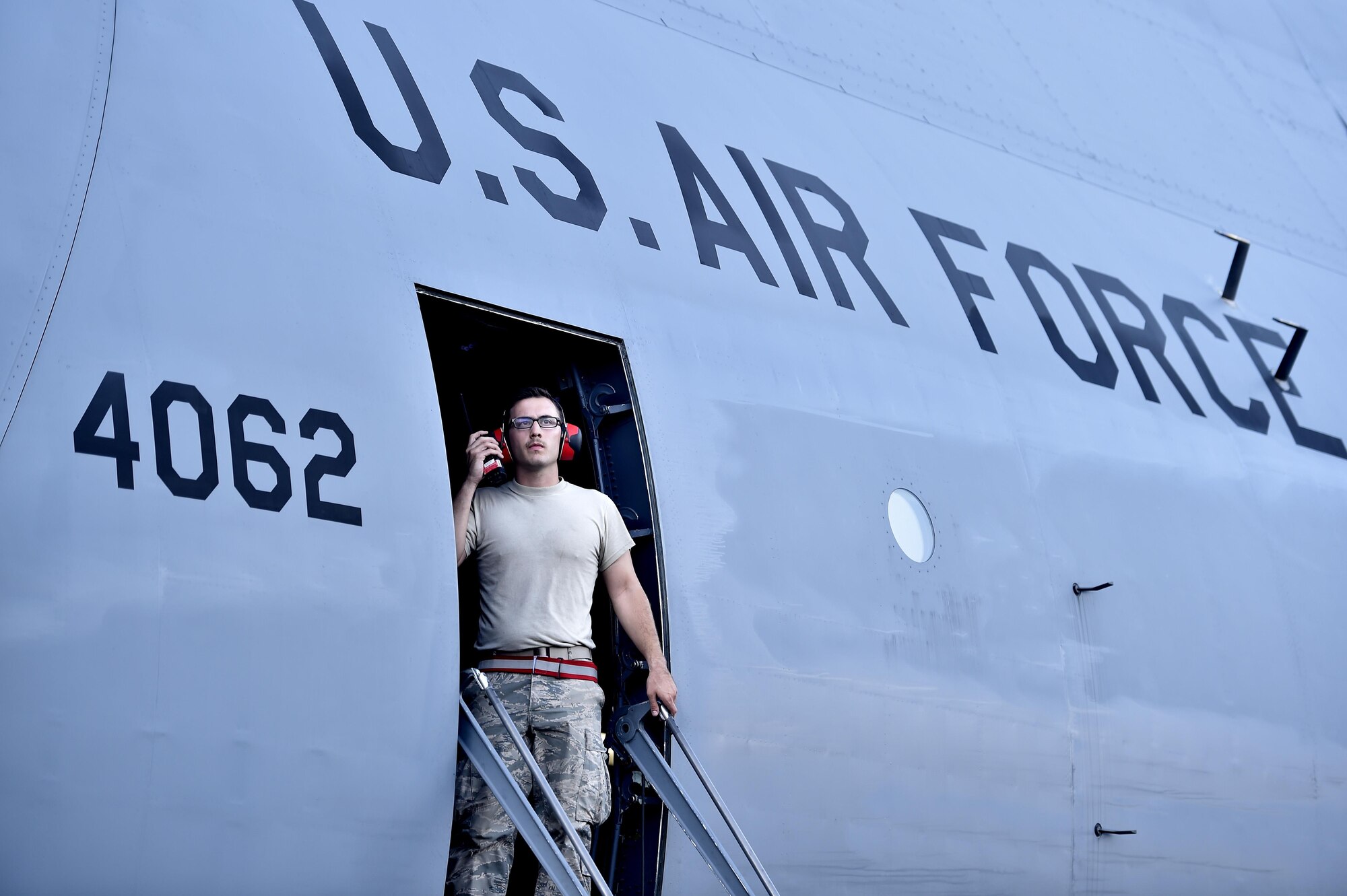 Staff Sgt. Thomas Ferris, 42nd Aerial Port Squadron cargo specialist, communicates with his team as they load cargo onto a C-5M Super Galaxy at Homestead Air Reserve Base, Fla, Sep. 16, 2017.  The 439th Airlift Wing from Westover Air Reserve Base, Mass., deployed approximately 50 Airmen in support of Hurricane Irma relief efforts. (U.S. Air Force photo by Tech. Sgt. Liliana Moreno/Released)