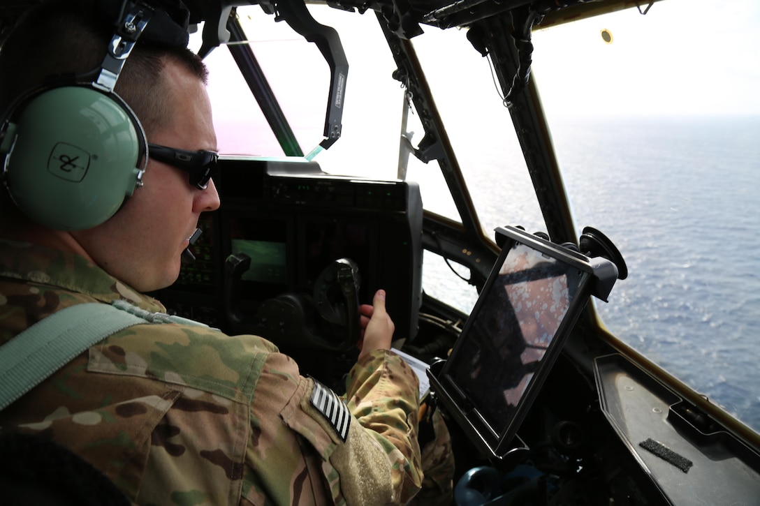 A U.S. Air Force pilot flies a C-130 full of hurricane relief personnel, including service members with Joint Task Force - Leeward Islands, from San Juan, Puerto Rico, to Simpson Bay, Sint Maarten