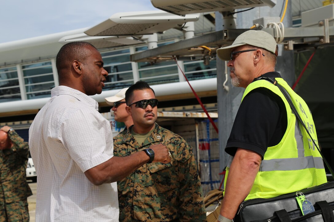 U.S. service members with Joint Task Force - Leeward Islands speak with a Federal Aviation Administration airport inspector at Princess Juliana International Airport in Saint Maarten, Sept. 15, 2017.