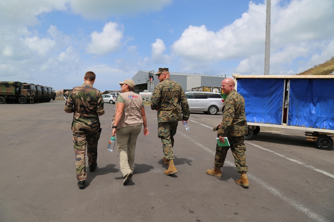 A French military leader walks with Anne Galegor, a representative of USAID, U.S. Marine Col. Michael V. Samarov, and Sgt. Maj. Glenn D. Bragg, the JTF-LI sergeant major, at the Grand Case Airport in Saint Martin