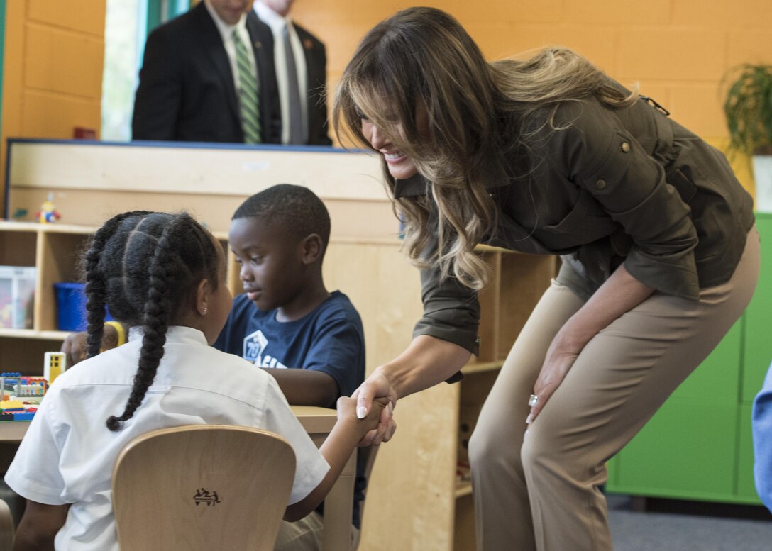 First lady shakes hands with girl.