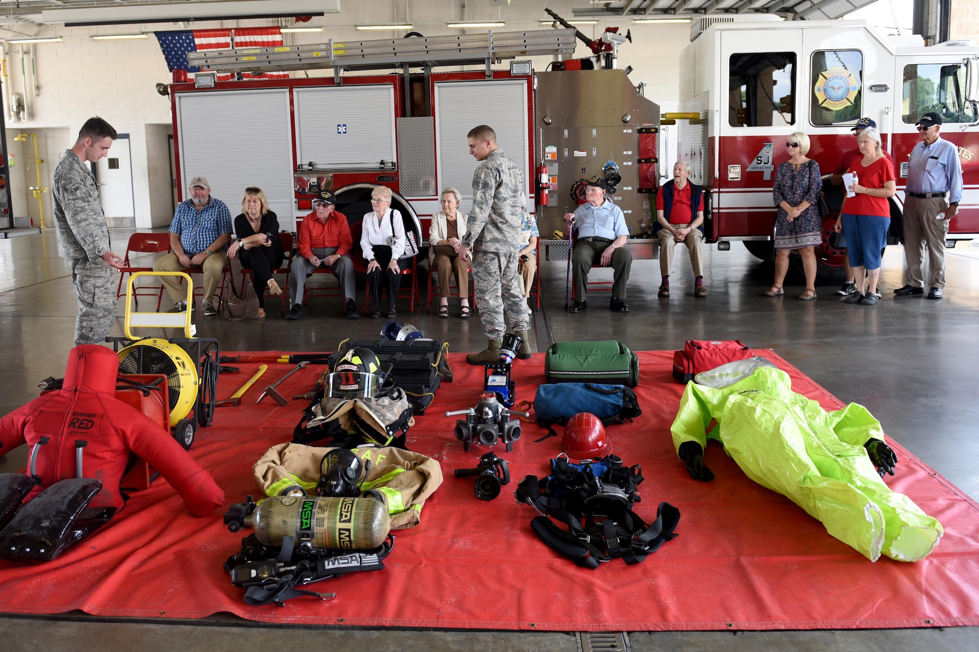 Members of the 4th Civil Engineering Squadron fire department present and explain the different pieces of equipment throughout a fire department, during the 4th Fighter Wing 75th Anniversary Tour, Sept. 15,2017, at Seymour Johnson Air Force Base, North Carolina. The tour also consisted of a readiness stop, which allowed spectators to experience the training the pilots go through when preparing to conduct overseas contingency operations through a simulator. (U.S. Air Force photo by Airman 1st Class Miranda A. Loera)