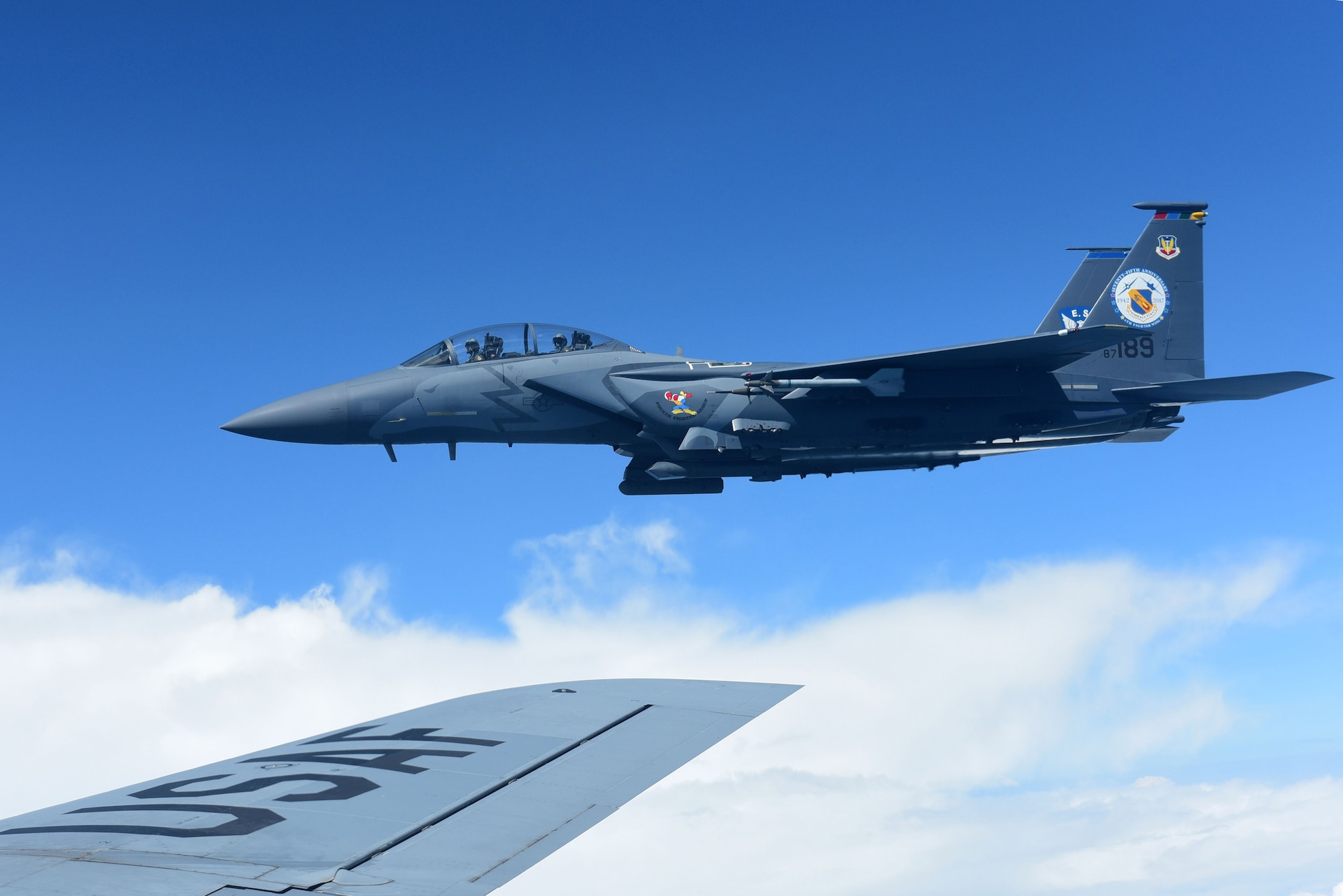A 4th Fighter Wing F-15E Strike Eagle heritage paint scheme aircraft flies next to a KC-135R Stratotanker, Sept. 14, 2017, in the skies above the North Carolina coastline.