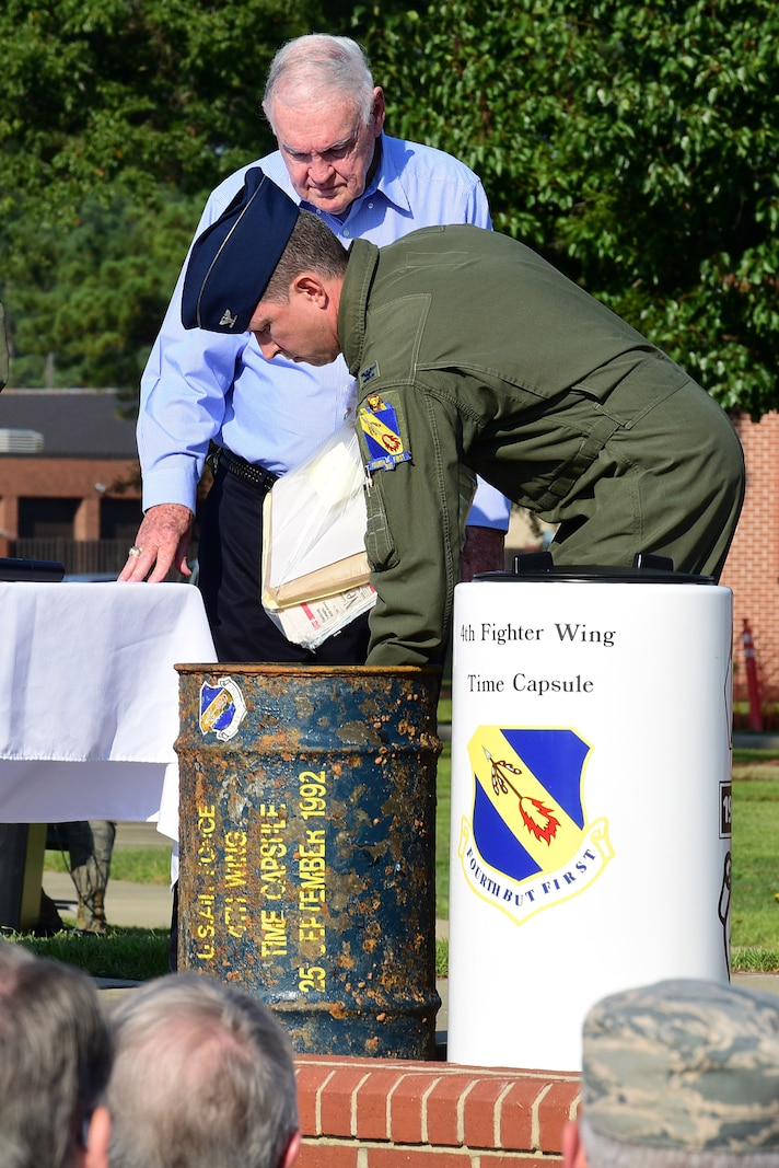 Col. Christopher Sage, 4th Fighter Wing commander, unveils the contents of a time capsule buried in 1992 with Bob Hill, Sept. 15, 2017, at Seymour Johnson Air Force Base, North Carolina. Hill attended the initial burial in 1967 and previous burial of the time capsule in 1992. (U.S. Air Force photo by Airman 1st Class Kenneth Boyton)