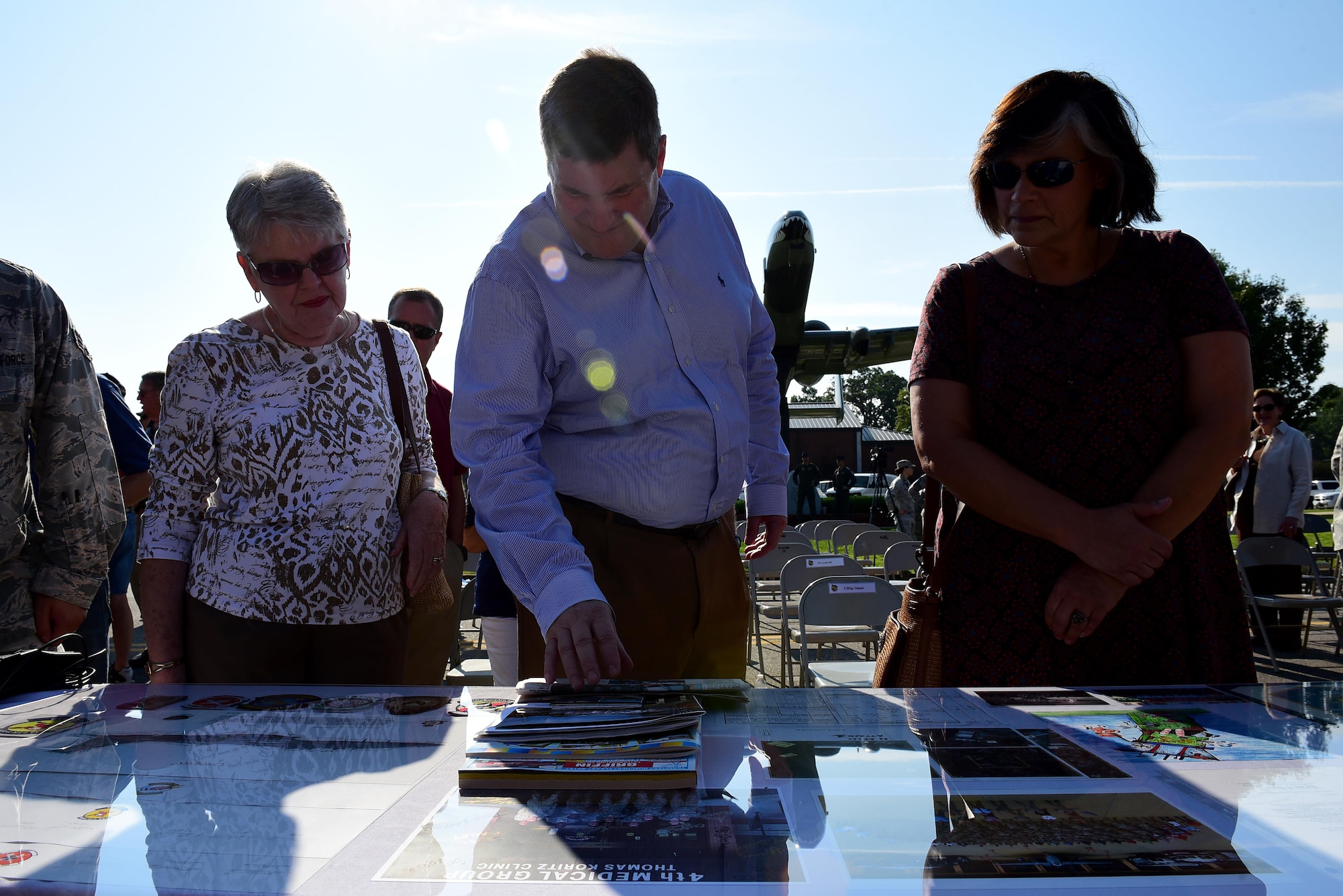 Members from Team Seymour and Goldsboro look at new items to be added to the new time capsule, Sept. 15, 2017, at Seymour Johnson Air Force Base, North Carolina. The contents from the 1992 capsule will be in the new capsule, along with digitized copies of some items too fragile to be buried for another 25 years. (U.S. Air Force photo by Airman 1st Class Kenneth Boyton)