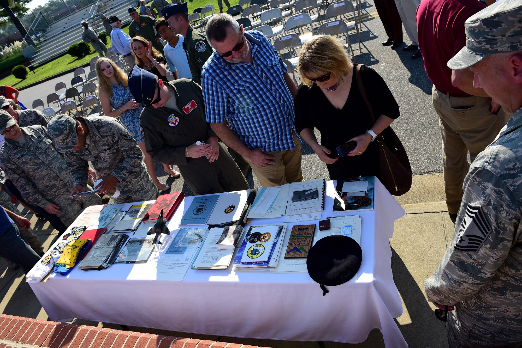 The audience and members from Team Seymour view the contents of the 1992 time capsule, Sept. 15, 2017, at Seymour Johnson Air Force Base, North Carolina. Some of the items included a copy of the local newspaper, 334th Fighter Squadron shirt, photos and a small F-4 Phantom II static. (U.S. Air Force photo by Airman 1st Class Kenneth Boyton)