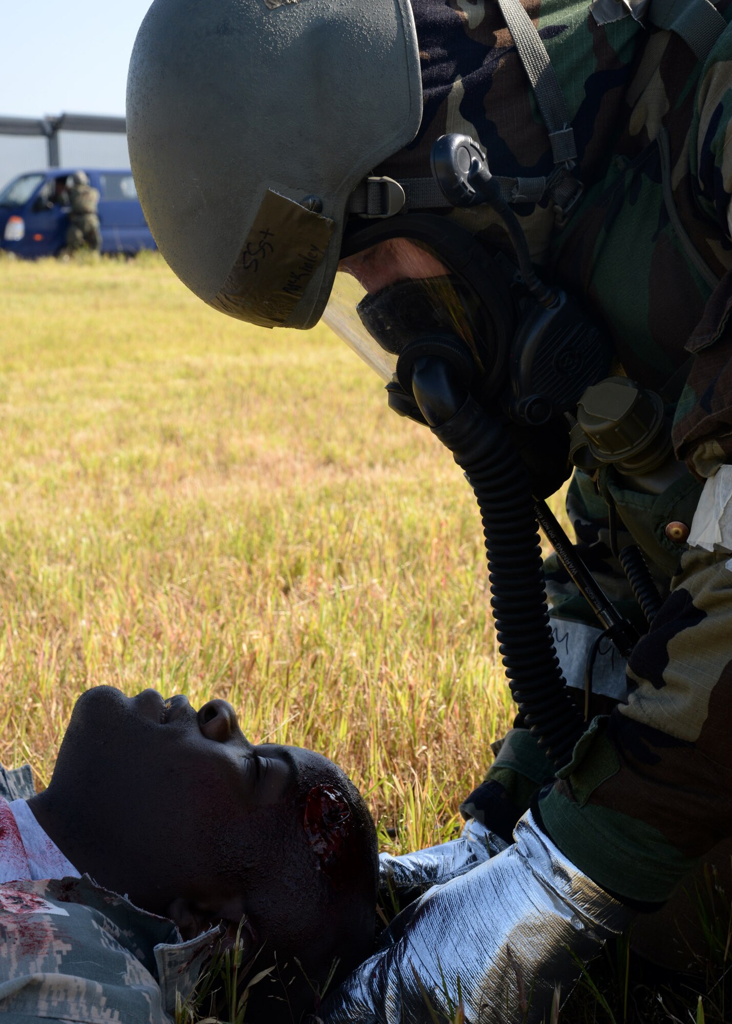 Staff Sgt. Brian McKinley, right, 51st Civil Engineer Squadron fire department crew chief, holds the cervical spine of Staff Sgt. Dennis Middleton, 51st Communication Squadron project manager, during a mass casualty scenario of exercise Beverly Herd 17-3 at Osan Air Base, Republic of Korea September 18, 2017. As part of the First Response Team, McKinley arrived before medical personnel and administered first-aid to injured victims. (U.S. Air Force photo by Tech Sgt. Ashley Tyler/Released)