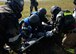 Members of the 51st Medical Group and 51st Civil Engineer Fire Department transfer Airman 1st Class Edwin Olivares, 51st Medical Support Squadron outpatient records technician, to a stretcher during a mass casualty scenario of exercise Beverly Herd 17-3 at Osan Air Base, Republic of Korea September 18, 2017. The scenario was held to examine medical personnel’s and first responders’ ability to quickly and appropriately treat a number of casualties in an emergency following the explosion of a simulated theater ballistic missile. (U.S. Air Force photo by Tech Sgt. Ashley Tyler/Released)