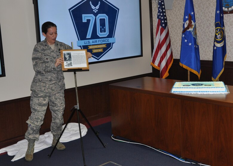 Col. Jean Eisenhut, 5th Air Force chief of Staff, unveils the dedication plaque for the “Wolfe Conference Room,” honoring Lt. Gen. Kenneth Wolfe, the first commander of 5th Air Force in the newly independent service, during 5th Air Force’s celebration of the 70th birthday of the U.S. Air Force, Sept. 18, 2017. (U.S. Air Force photo by Maj. George Tobias)